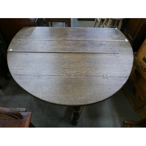 199 - A George III oak gateleg table and an oak linenfold panel bureau