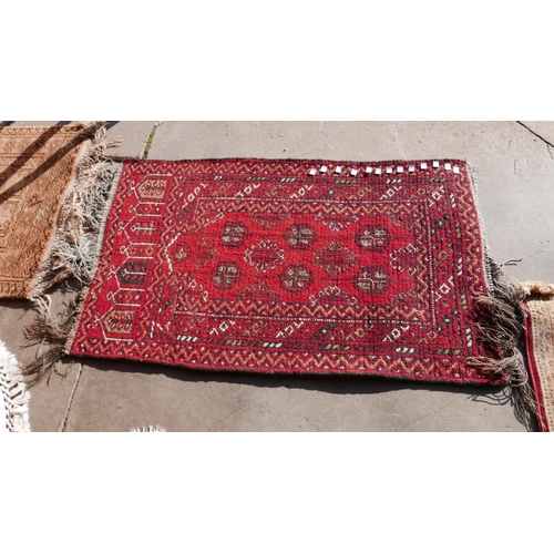 237 - Two double sided red ground prayer rugs, another red ground rug and two others