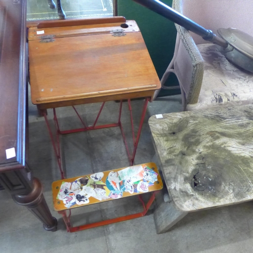 249 - A child's small school desk, an elm stool, a copper warming pan and a folding card table