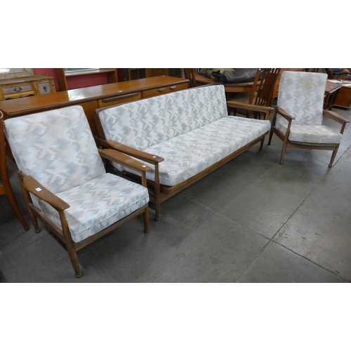 28 - A Guy Rogers teak and fabric upholstered Manhattan range three piece lounge suite, comprising settee... 