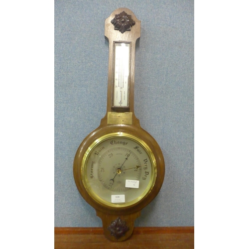 328 - An early 20th Century carved oak aneroid barometer