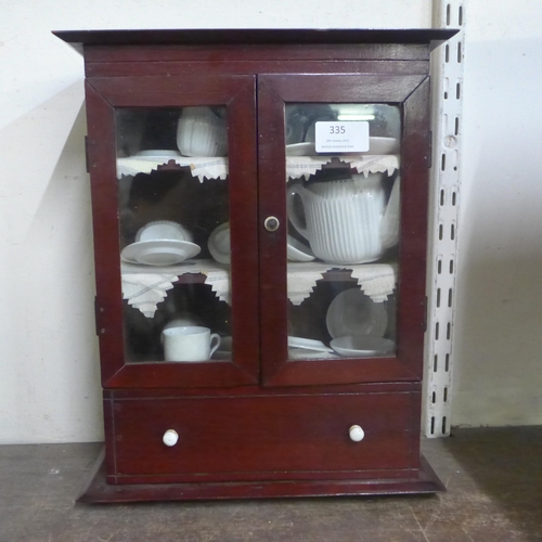 335 - A Victorian apprentices mahogany bookcase with miniature tea set