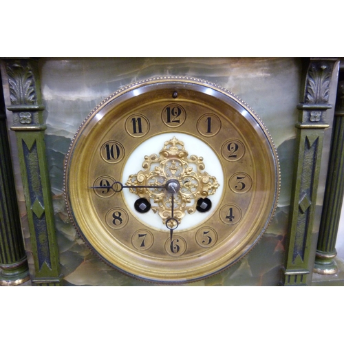 350 - A brass and onyx clock garniture