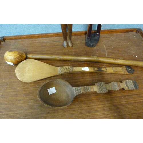 353 - A figure of an African man with paddle, a knobkerrie and two spoons