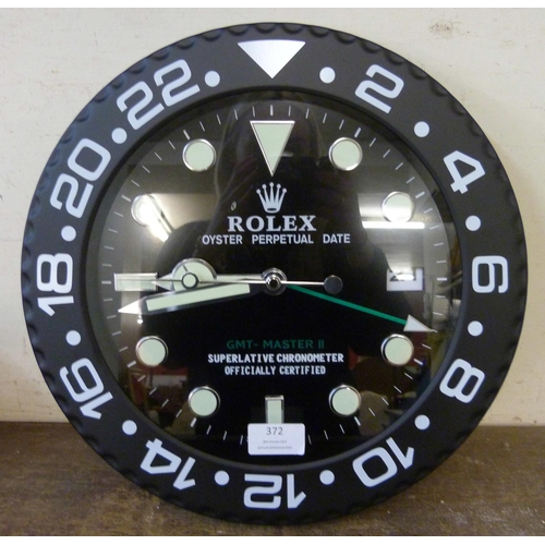 372 - A Rolex style dealer's display wall clock