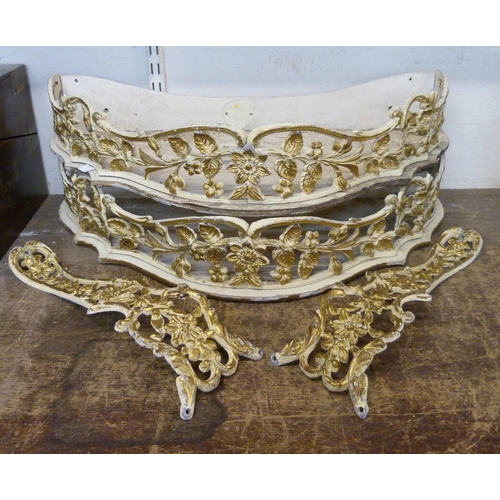 390 - A pair of cream and parcel gilt demi lune wall shelves