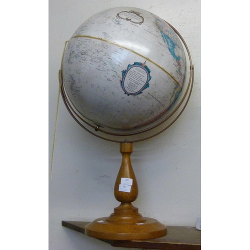 392 - A desk top terrestrial globe, on oak stand