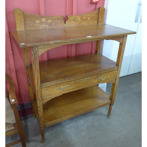 73 - An Arts and Crafts oak three tier buffet