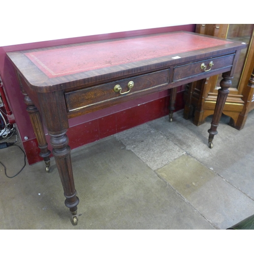 86 - A Victorian mahogany and red leather topped two drawer writing table