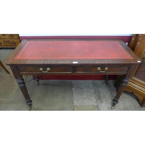 86 - A Victorian mahogany and red leather topped two drawer writing table