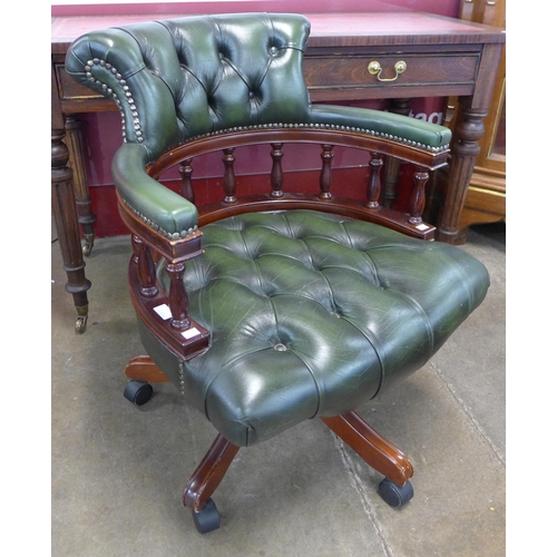 87 - A mahogany and green leather Captain's revolving desk chair