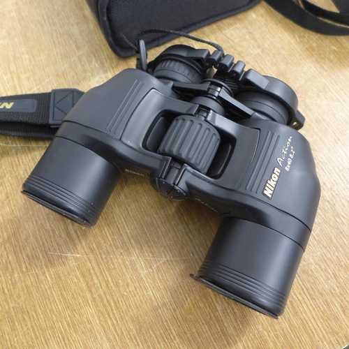 2061 - A Nikon Action 8x40 8.2° binoculars and 2 camera's