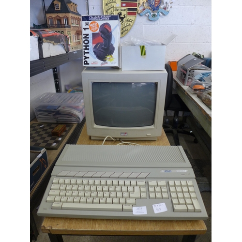 2121 - An Atari 1040 ST vintage computer system with monitor, joy stick, hand book and software etc.