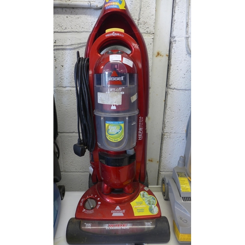 2235 - A Bissell bagless lift-off vacuum cleaner and a Vax Rapide carpet cleaner