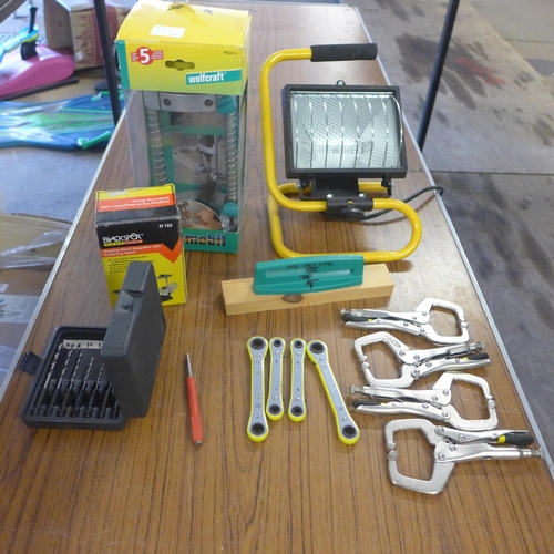 2335 - A box of assorted tools including work lights and drill jig, clamps scissor sharpener etc.