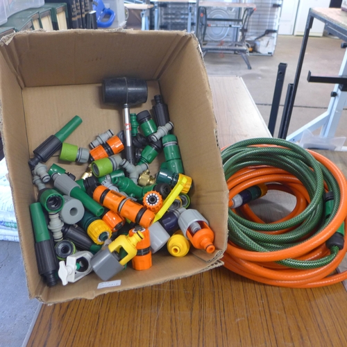 2362 - A box of hose pipe attachments and hose pipe