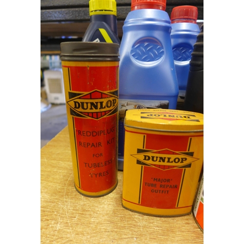 2373 - Two boxes of assorted motor oils, and vintage tins including Dunlop tire repair kit and major tube r... 