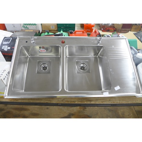 2357 - A twin stainless steel sink with waste and fittings