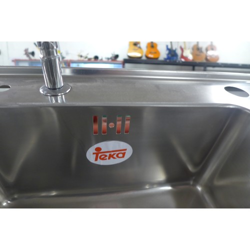 2357 - A twin stainless steel sink with waste and fittings