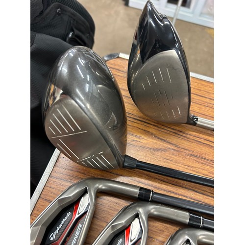 2264 - A Titleist golf bag with a set of Taylor Made Aero Burners graphite shaft irons (6,7,8,9,pw,sw) ping... 