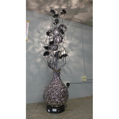 1496 - A silver and black floral lamp