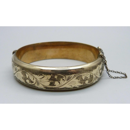 1011 - A rolled gold bangle, marked '1/5th 9ct RG'