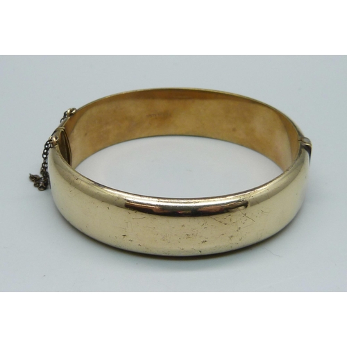 1011 - A rolled gold bangle, marked '1/5th 9ct RG'