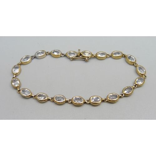 1020 - A silver gilt and crystal line bracelet, marked on end ring