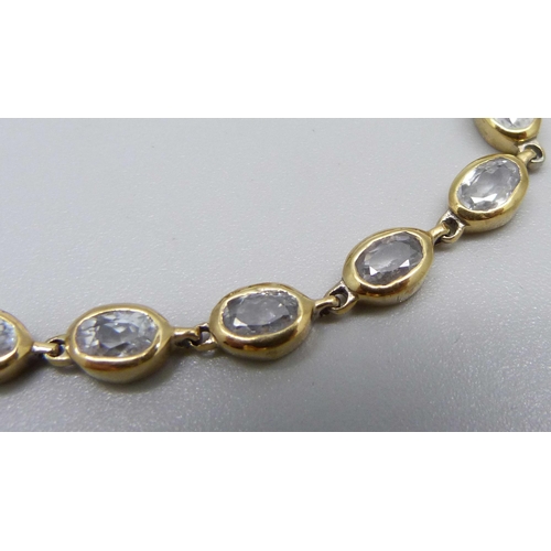 1020 - A silver gilt and crystal line bracelet, marked on end ring