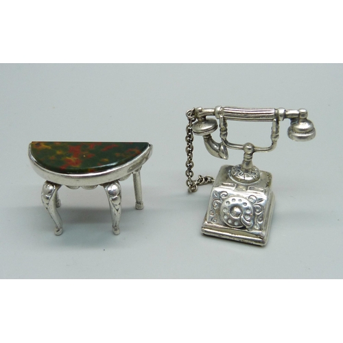 1027 - A hallmarked novelty miniature silver telephone and a similar side table set with bloodstone, table ... 