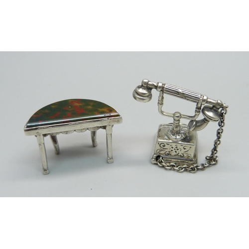 1027 - A hallmarked novelty miniature silver telephone and a similar side table set with bloodstone, table ... 