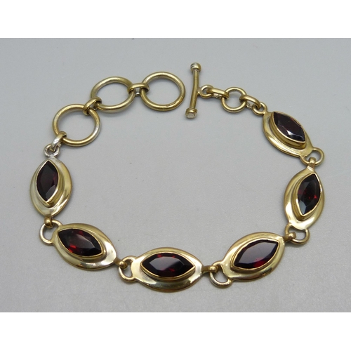 1032 - A silver gilt, marquise garnet bracelet