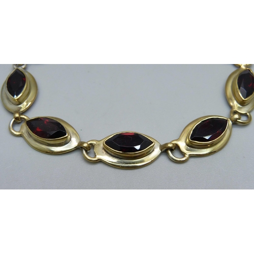 1032 - A silver gilt, marquise garnet bracelet