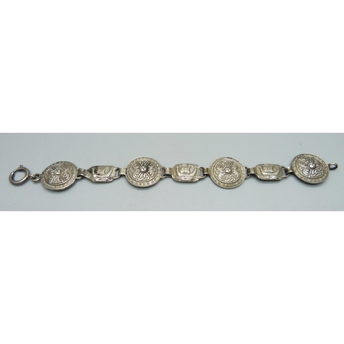 1038 - A hallmarked Scottish silver Viking shield and longboat bracelet, hallmark Edinburgh, Robert Allison... 