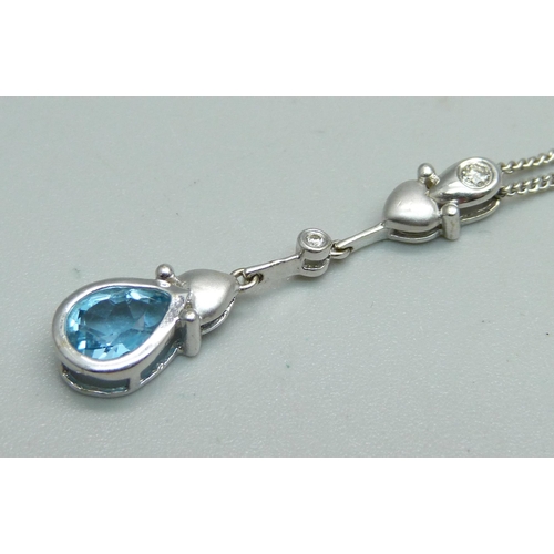 1042 - An 18ct white gold, diamond and topaz pendant on chain, 5g, 46cm