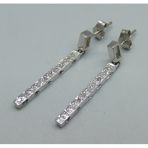 1043 - A pair of 9ct white gold and diamond earrings, 2g