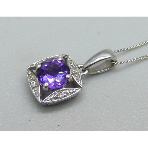 1044 - A 9ct white gold pendant set with a purple stone and diamonds on a fine 9ct white gold chain, 1.2g, ... 