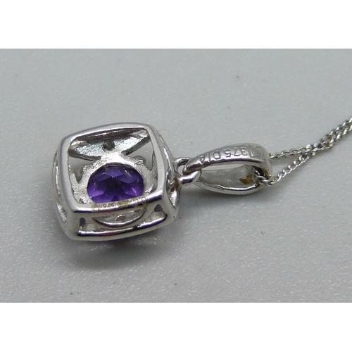 1044 - A 9ct white gold pendant set with a purple stone and diamonds on a fine 9ct white gold chain, 1.2g, ... 