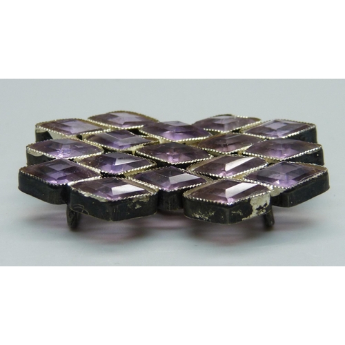 1064 - A white metal and amethyst coloured stone belt buckle, 35mm x 55mm