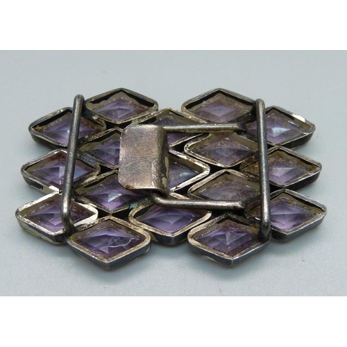 1064 - A white metal and amethyst coloured stone belt buckle, 35mm x 55mm