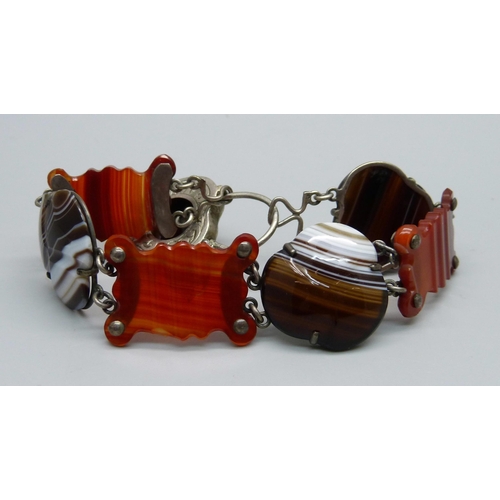 1065 - A Scottish agate set white metal bracelet with padlock clasp