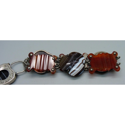 1065 - A Scottish agate set white metal bracelet with padlock clasp