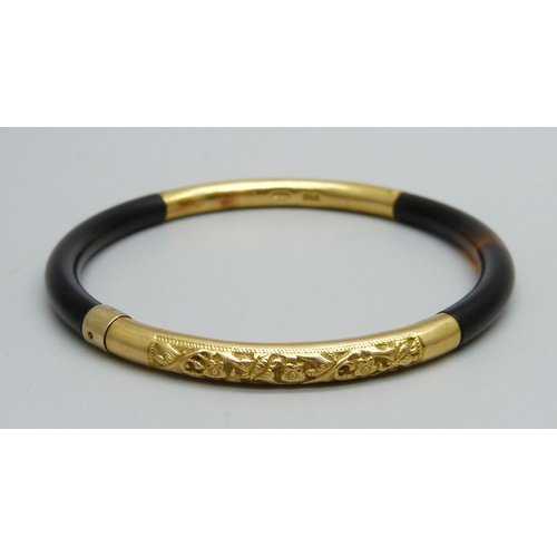 1066 - A yellow metal and tortoiseshell bangle, continental control marks, tests as high carat gold