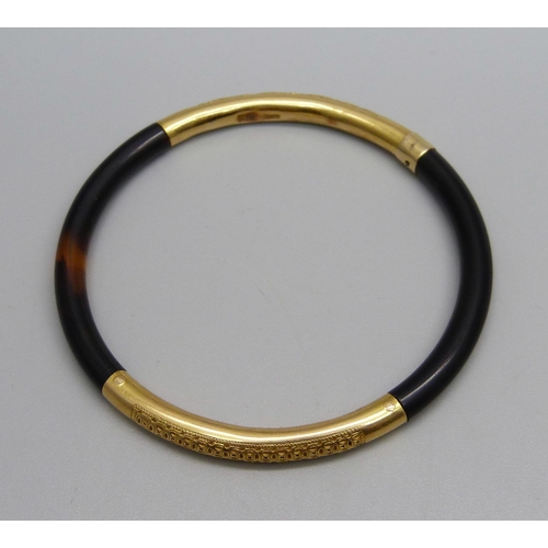 1066 - A yellow metal and tortoiseshell bangle, continental control marks, tests as high carat gold