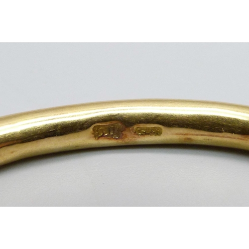 1066 - A yellow metal and tortoiseshell bangle, continental control marks, tests as high carat gold