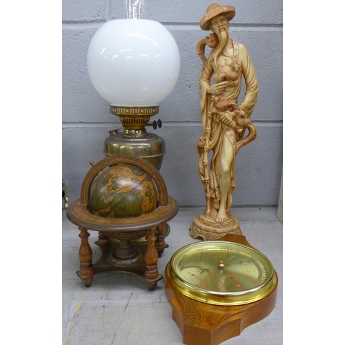 1104 - A barometer, an oil lamp, a figure and a globe **PLEASE NOTE THIS LOT IS NOT ELIGIBLE FOR POSTING AN... 