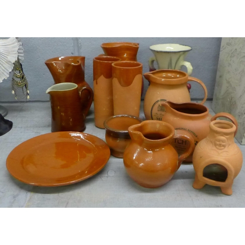 1109 - A collection of terracotta jugs, other china including a vase, two chargers, Bourne Daisy jug, brass... 