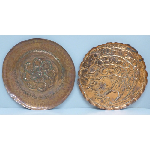 601 - Two embossed copper Arts and Crafts dishes, 22.5cm and 24.5cm