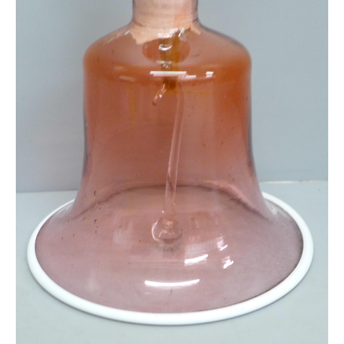 606 - A circa 1900 cranberry glass bell, clacker and internal fitting a/f, 30cm tall