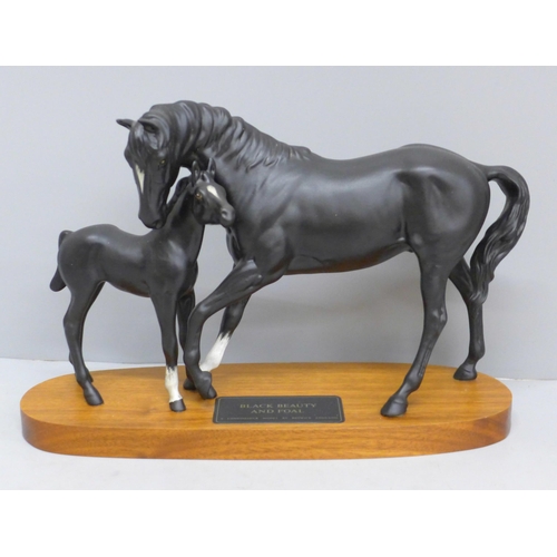 609 - A Beswick figure group, Black Beauty and Foal